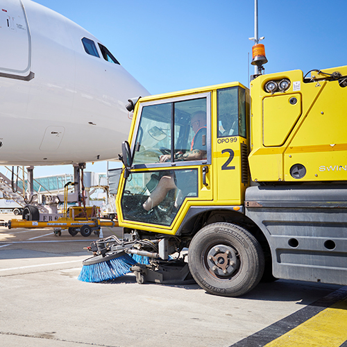 a photograph of an airfield sweeper vehicle that runs on HVO fuel